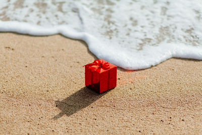 High angle view of christmas present on shore at beach