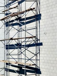 Low angle view of metallic structure against building