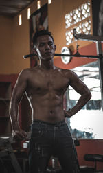 Portrait of young man standing in gym