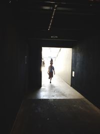 Woman walking in tunnel