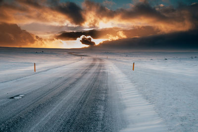 Scenic view of road during winter against sky