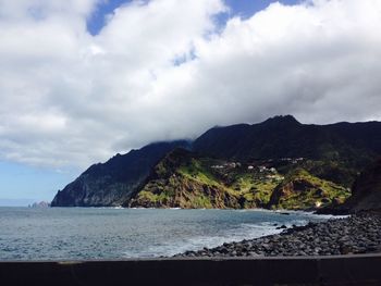 Scenic view of mountains against cloudy sky