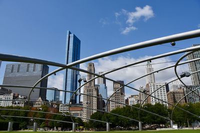 Low angle view of skyscrapers against blue sky