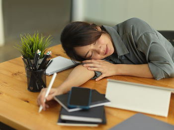 Portrait of woman relaxing on table at home