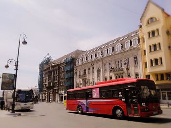 Car on street against buildings in city