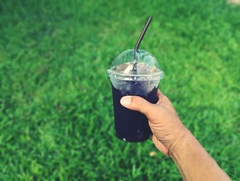 Cropped image of person holding drink