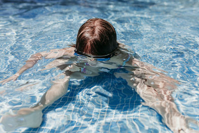 High angle view of woman swimming in pool