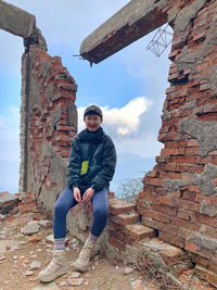 Portrait of young man against wall