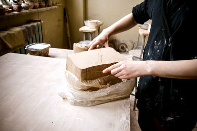 White clay preparation for work. cutting layers of clay pieces for sculpting in workshop of potter 