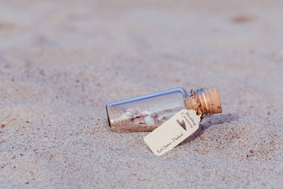 Close up of bottle on sand