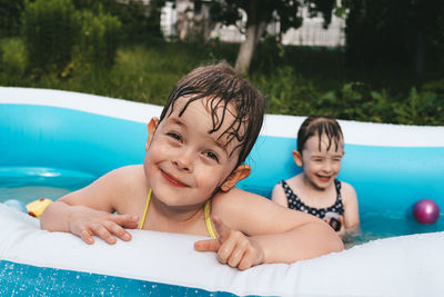 Smiling happy girl in swimming pool. cheerful children in the pool. 