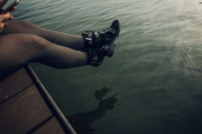 Low section of woman swimming in sea