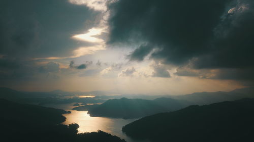 Scenic view of silhouette mountains against dramatic sky