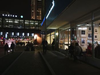 Crowd in illuminated city at night