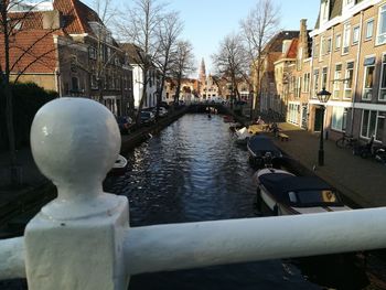 Bridge over canal amidst buildings in city