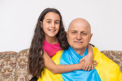 Elderly man and girl with the flag of ukraine