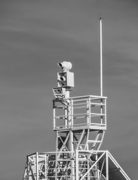 Low angle view of communications tower against sky