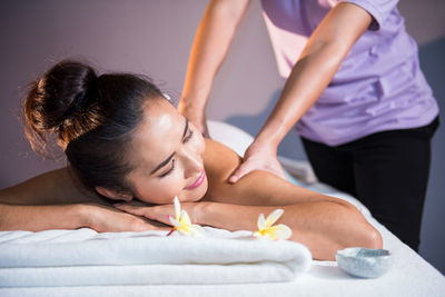 Midsection of woman lying on bed