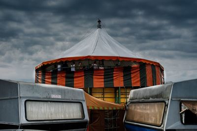 View of amusement park against cloudy sky