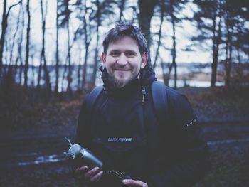 Portrait of smiling young man in forest