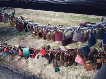 Close-up of padlocks hanging on railing