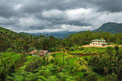 House at remote village isolated with mountain coverd clouds and green forests