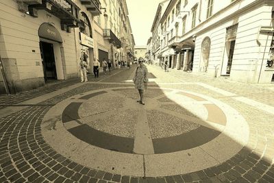 Man walking on zebra crossing in city