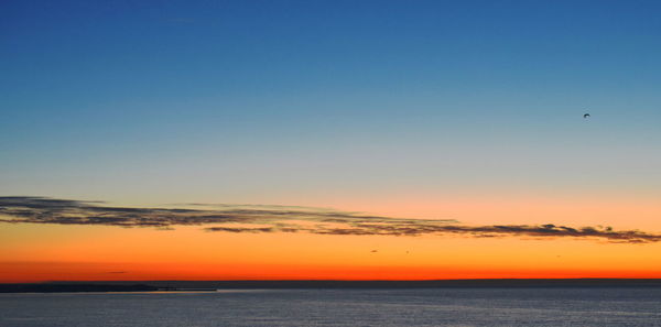 Scenic view of sea against clear sky during sunset