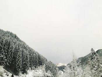 Snow covered landscape against clear sky