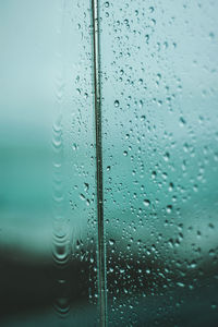 Full frame shot of wet glass window in rainy season