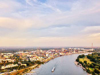 High angle view of buildings by sea against sky