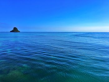 Scenic view of sea against blue sky