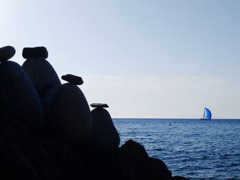 Man on sea against clear sky