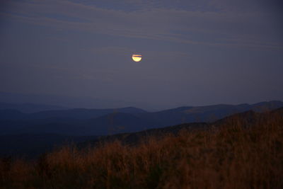 Scenic view of landscape against sky at night