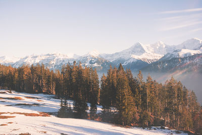 Scenic view of snow covered mountains against sky