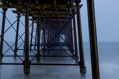 Silhouette of pier over sea against sky