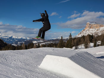 Full length of man jumping in snow