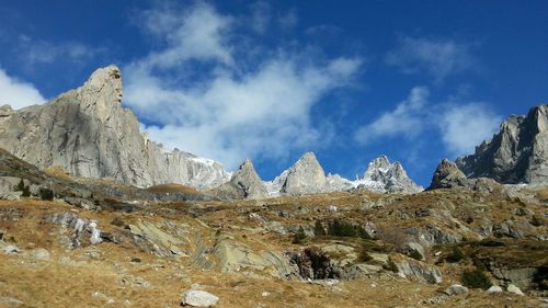 Scenic view of mountains against cloudy sky