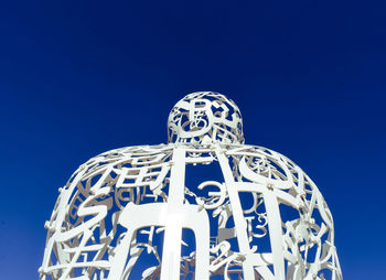 Low angle view of statue against blue sky