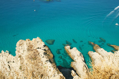 High angle view of rocks in sea at capo vaticano 