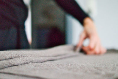 Low section of woman standing on bed