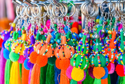 Close-up of multi colored key rings hanging for sale