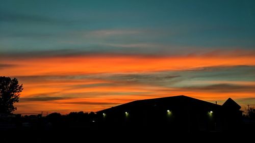 Silhouette buildings against sky during sunset