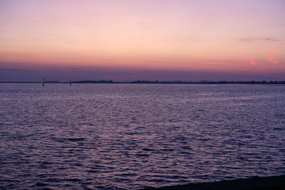 Scenic view of sea against romantic sky at sunset