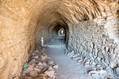 View of stone wall in tunnel