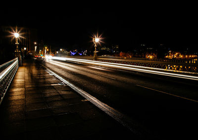 Light trails on road in city at night
