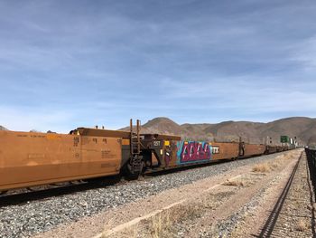 Train on railroad track against sky