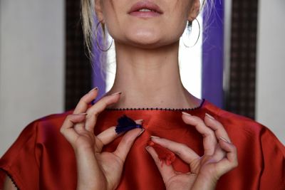 Close-up of woman holding red hand