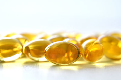 Close-up of yellow glasses over white background