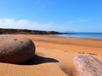 Scenic view of beach against blue sky